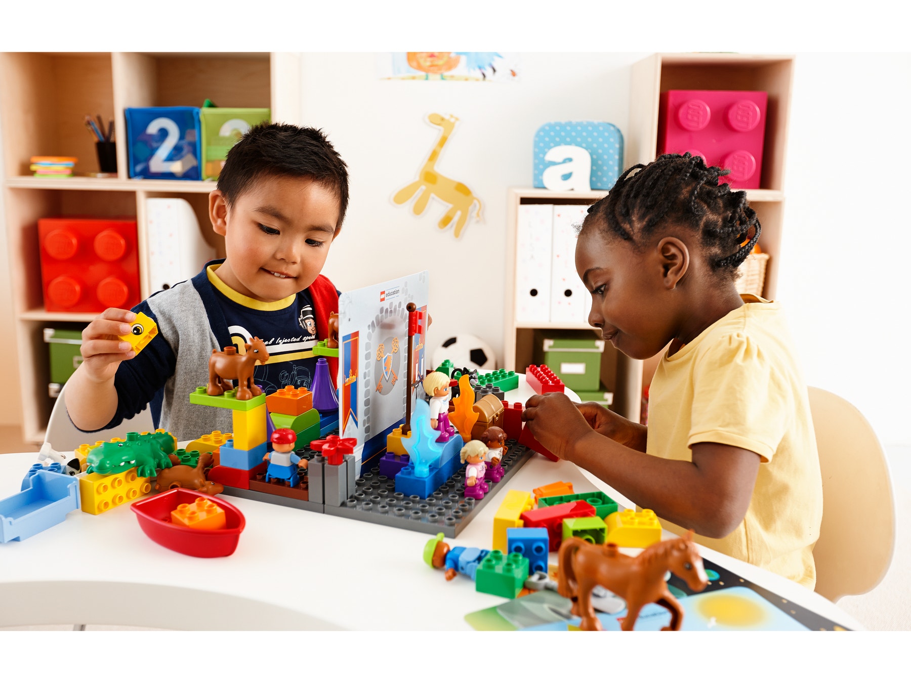 Kindergarten students working with a role play set