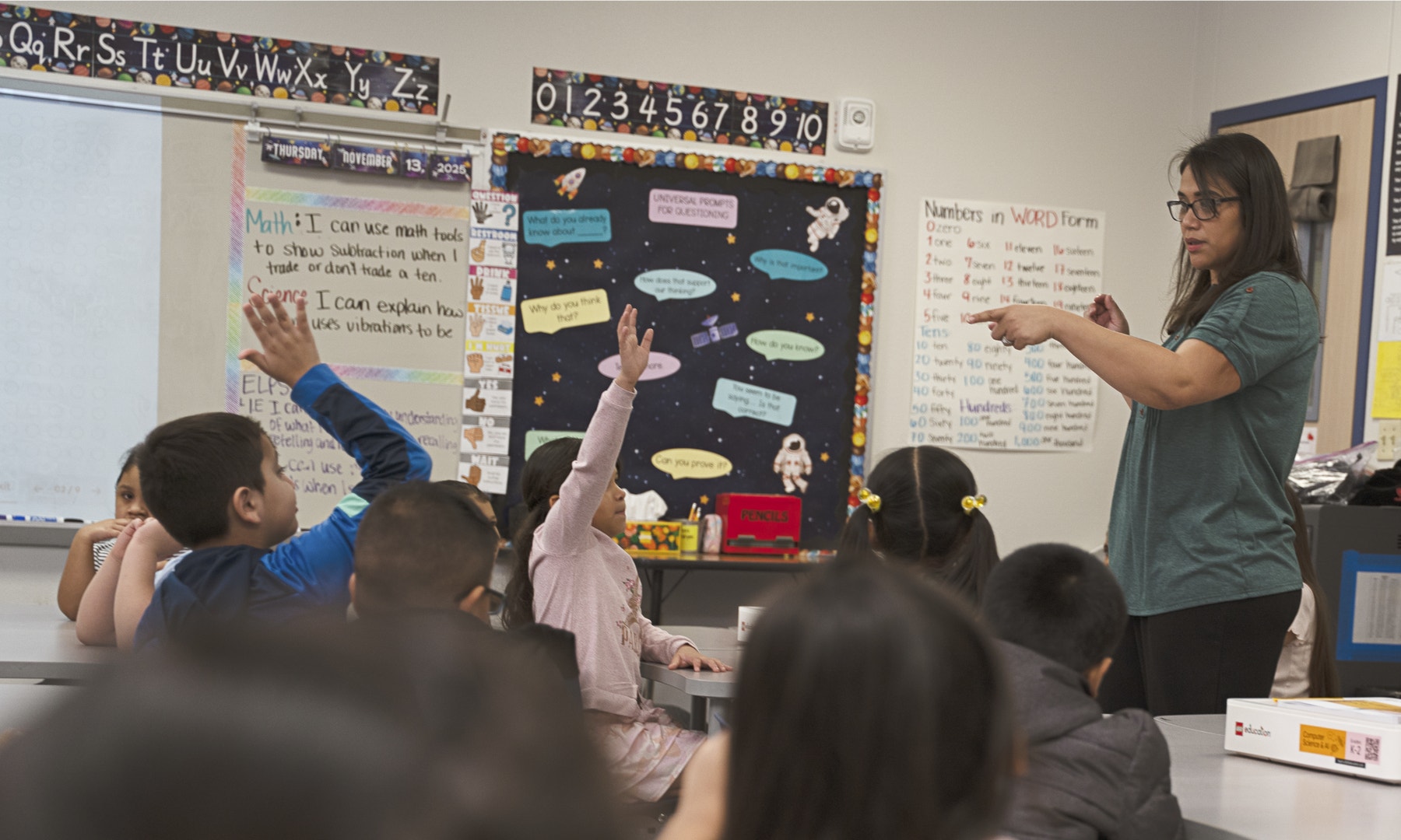 CSAI_45520_US_Lifestyle_students raising hands_4000x2400.png