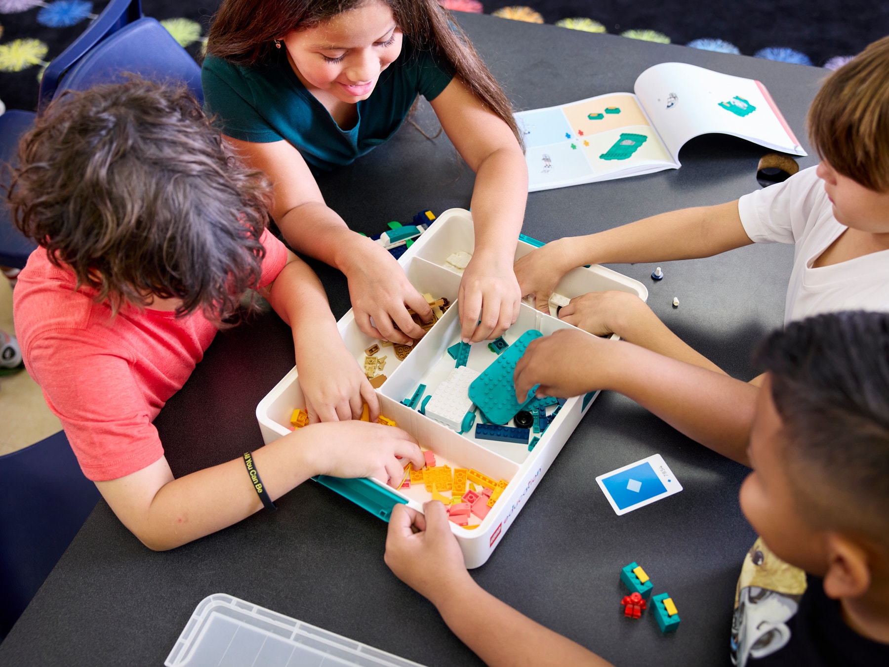 Four students building LEGO models using LEGO Education Science Kit.